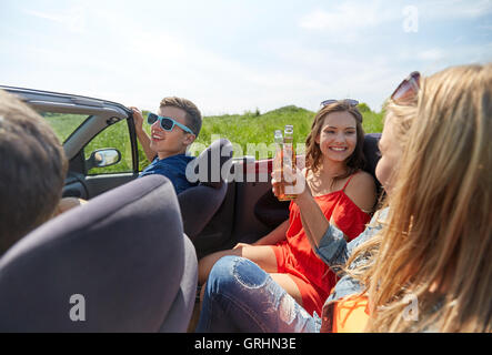 Happy friends roulant en voiture cabriolet avec de la bière Banque D'Images