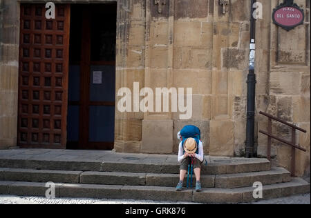 Un pèlerin moderne repose sur une place de Santo Domingo de la Calzada, l'Espagne le 26 août, 2016. Photographie d'auteur John Voos Banque D'Images