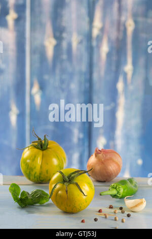 Heirloom tomatoes et les feuilles de basilic et des épices Banque D'Images