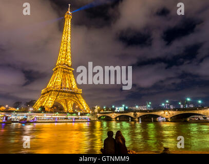 Paris, France - 14 Février 2016 : La Tour Eiffel illuminée, la Seine et la silhouette de deux amoureux. Banque D'Images