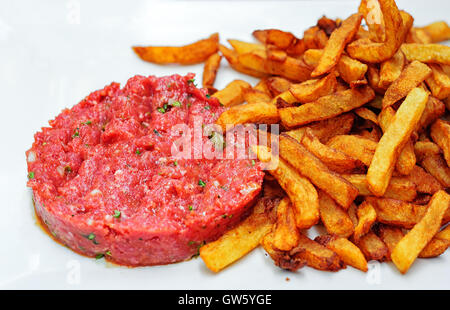 Tartare de boeuf haché cru la viande servie avec frites potato chips isolated on white Banque D'Images