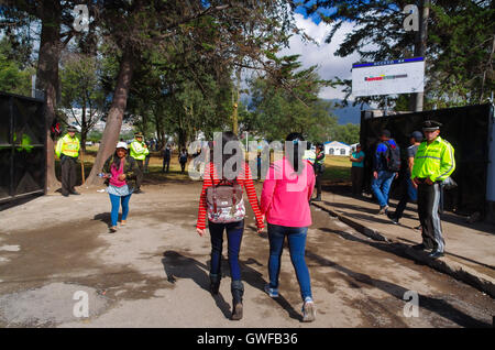 QUITO, ÉQUATEUR - le 7 juillet 2015 : Deux jeunes filles entrant à la place d'entendre le pape Francisco masse, la police garde l'entrée portes Banque D'Images