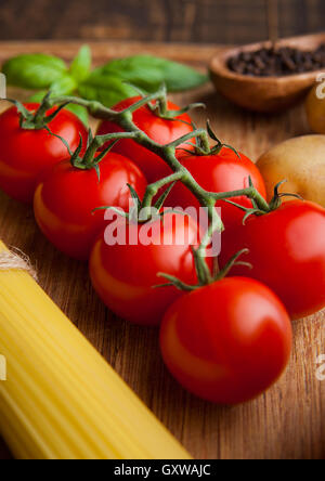 Les tomates fraîches avec des spaghettis et du poivre sur la cuisine. Basil le contexte Banque D'Images