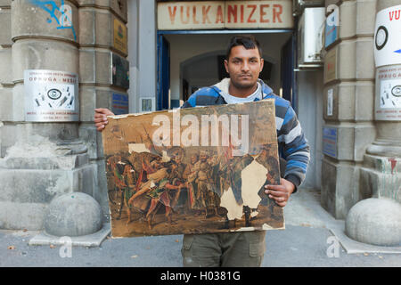 ZAGREB, CROATIE - le 17 octobre 2013 : Roma man holding a ruiné la peinture recueillie à partir de la rue dépotoir. Banque D'Images