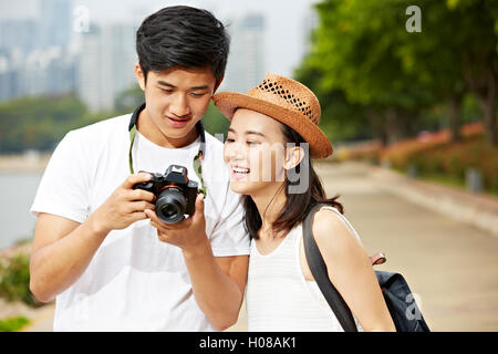 Jeune couple de touristes à la recherche de l'appareil photo au contrôle moniteur photos prises Banque D'Images