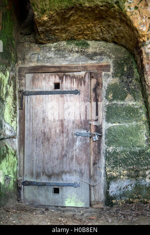 Porte de bois dans le mur de pierre de la roche Château Banque D'Images