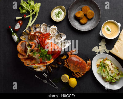 Le mezza traiteur repas de fruits de mer avec le crabe, homard, crevettes, huîtres, palourdes, moules, de citron, de la laitue et de la soupe sur la table Banque D'Images