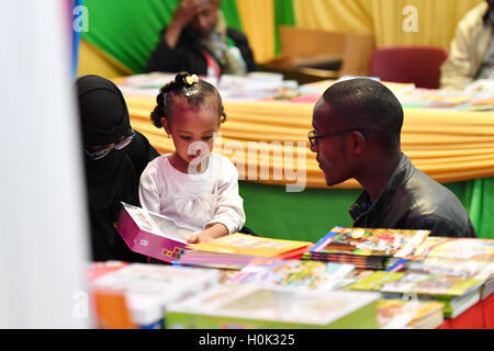 Nairobi, Kenya. Sep 21, 2016. Un exposant aide une petite fille de choisir des livres à la 19e Foire internationale du livre de Nairobi à Nairobi, Kenya, 21 septembre 2016. Étant l'une des plus anciennes foires du livre en Afrique de l'Est, les 5 jours 19e Foire internationale du livre de Nairobi le coup d'ici mercredi avec les éditeurs de tout le continent et le monde. © Sun Ruibo/Xinhua/Alamy Live News Banque D'Images