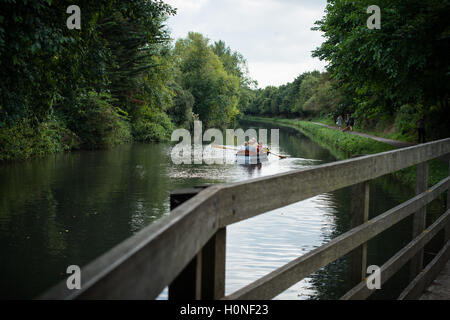 Une famille ramer un bateau le long du canal à Chichester Chichester, West Sussex, Angleterre. Banque D'Images