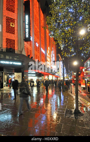 House of Fraser department store avec les consommateurs au Royaume-Uni Oxford street avec des lumières de Noël Réflexions soir de pluie pour le shopping à Londres West End Banque D'Images