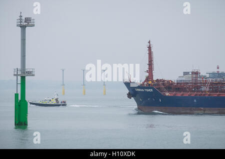 Un navire de fret de Cumbrie, Fisher, quitte le port de Portsmouth, passé le feu de navigation pieux qui ont été installés dans le Solent. Banque D'Images