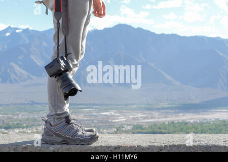 Photographe professionnel dans l'appareil photo DSLR holding mountain scene. Banque D'Images