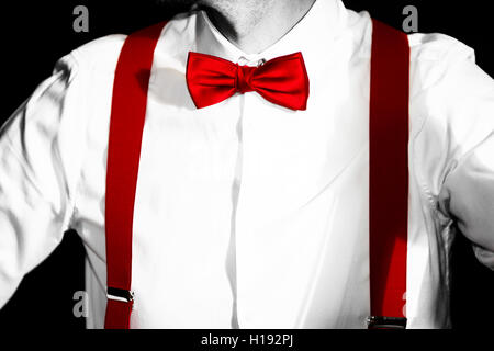 Costume conceptuel. Red Bow-tie et accolades. Jazzbow chemise blanche sur l'arrière-plan. L'élégance et de chic. Banque D'Images