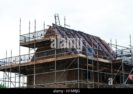 Apartment en construction avec des matériaux de la toiture en place prêt à fixer en place et les échafaudages érigés pour les constructeurs Banque D'Images