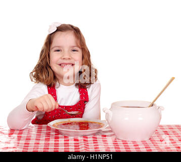 Happy little girl eating Red Tomato Soup Banque D'Images