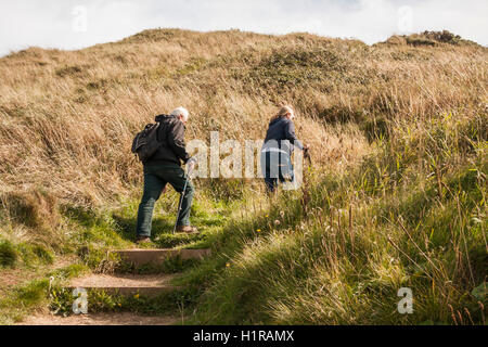 Mâles et femelles matures les randonneurs l'ascension de la pente raide sur le Cleveland Way à Saltburn by the Sea Banque D'Images