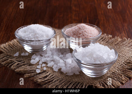 Three types of salt on dark background, selective focus Banque D'Images