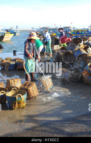 Lagi, Vietnam - 26 Février 2012 : les femmes locales sont le nettoyage leurs paniers qui ont été utilisés pour le transport de poissons de la voile Banque D'Images