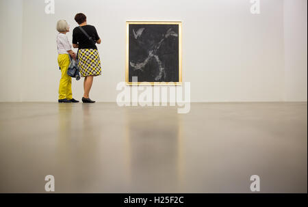 Reutlingen, Allemagne. 25 Septembre, 2016. Les gens observant la peinture 'ho trovato scarpe nere, 2014' par Georg Baselitz lors de l'ouverture de l'exposition de l'artiste Georg Baselitz et Albert Oehlen à Reutlingen, Allemagne, 25 septembre 2016. L'exposition est ouverte jusqu'au 15 janvier 2017. PHOTO : CHRISTOPH SCHMIDT/dpa/Alamy Live News Banque D'Images