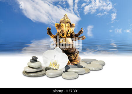 Ganesh ou Ganapati,zen stone,fleurs orchidée blanche et le ciel reflété dans l'eau Banque D'Images