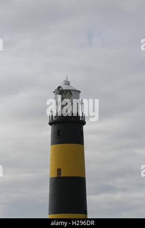 Phare entretenu avec deux hommes peignant le phare du comté de St John's point en Irlande du Nord. Banque D'Images