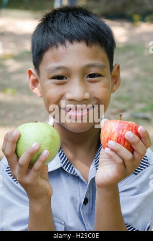 Enfant asiatique avec les produits frais de la goyave. Banque D'Images