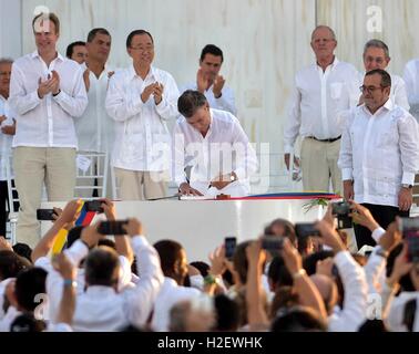 Carthagène, Colombie. 26 Septembre, 2016. Le président colombien Juan Manuel Santos, signe l'accord de paix avec le commandant des FARC Rodrigo Londono, droite, alors que les dirigeants du monde entier sur l'oeil au cours d'une cérémonie le 26 septembre 2016 à Carthagène, Colombie. L'accord prend fin 50 ans de conflit armé entre le gouvernement et les forces rebelles. Credit : Planetpix/Alamy Live News Banque D'Images