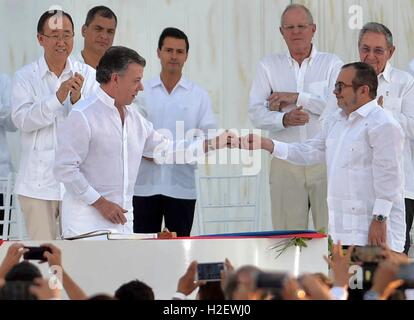 Carthagène, Colombie. 26 Septembre, 2016. Le président colombien Juan Manuel Santos, les mains le stylo au commandant des FARC Rodrigo Londono, droite, alors que les dirigeants du monde entier sur l'oeil au cours d'une cérémonie de signature le 26 septembre 2016 à Carthagène, Colombie. L'accord prend fin 50 ans de conflit armé entre le gouvernement et les forces rebelles. Credit : Planetpix/Alamy Live News Banque D'Images