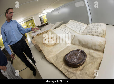 Wiesbaden, Allemagne. Sep 6, 2016. Archiviste scientifique Johann Zilien montrant un document de l'Eberbach couvent de 1183 au Capital de Hesse Archives à Wiesbaden, Allemagne, 6 septembre 2016. PHOTO : FRANK RUMPENHORST/dpa/Alamy Live News Banque D'Images