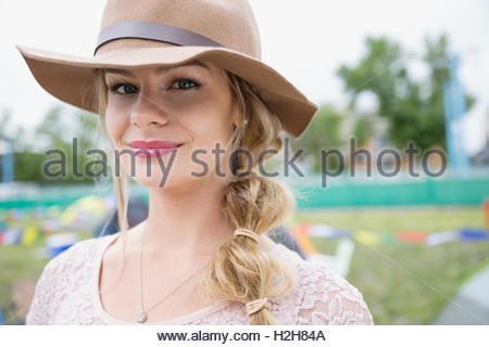 Portrait of smiling young blonde woman wearing hat