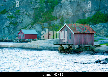 Stensvik, Suède - septembre 9, 2016 : l'environnement documentaire de old weathered les hangars à bateaux sur des pilotis de bois et de pierre par le wa Banque D'Images