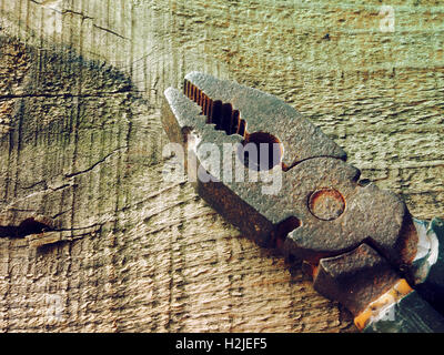 Old rusty pinces sur fond de table en bois ancien. Photo de style ancien Banque D'Images