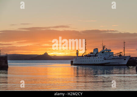 Penzance, Cornwall, UK. Le 30 septembre 2016. Météo britannique. Le soleil se lève sur St Michaels Mount, promettant une autre belle journée à Cornwall. On voit ici le Scillonian, attendant de prendre des marchandises et des gens partout à l'Îles Scilly. Crédit : Simon Maycock/Alamy Live News Banque D'Images