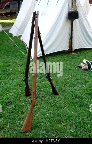 Trois fusils à silex à chargement par la tente de toile avec en arrière-plan. Banque D'Images