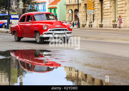 Scène de rue à La Havane : Chevrolet rouge American Classic Car et de réflexion dans la Vieille Havane, Cuba Banque D'Images