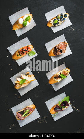 Crostini italiens avec divers accompagnements sur un papier blanc Banque D'Images