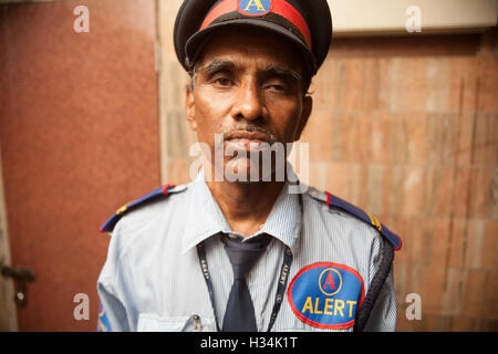 Gardien de sécurité appartenant à l'entreprise d'alerte protéger une propriété résidentielle coûteux dans la banlieue de Mumbai, Bombay, Inde. Banque D'Images