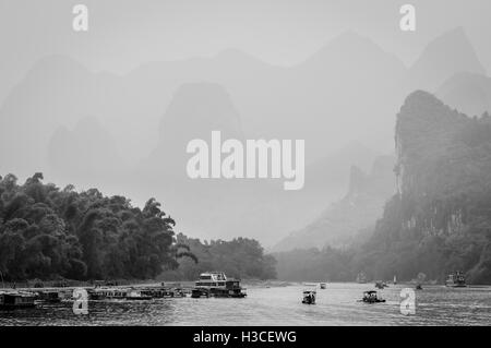 Bateau de croisière et les bateaux remplis de touristes voyages la magnifique route panoramique dans la brume le long de la rivière Li Banque D'Images