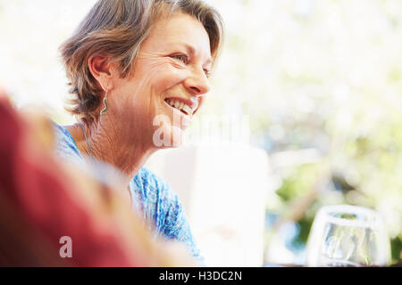 Smiling mature woman with Blonde hair assis à l'extérieur. Banque D'Images