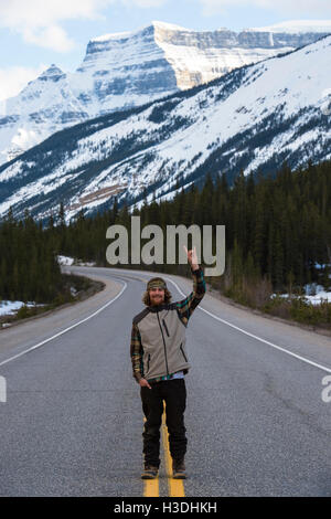 Snowboarder, debout au milieu de la route au Canada Banque D'Images