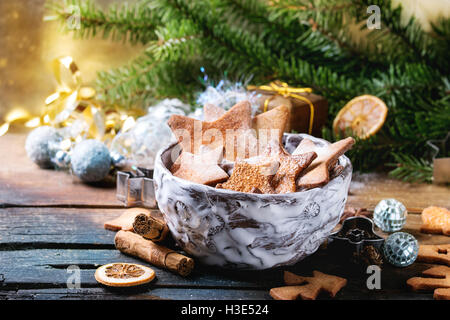 Bol de Noël fait maison shortbread cookies sucre étoile taille différentes avec du sucre en poudre et d'un emporte-pièce sur l'ancienne en bois Banque D'Images