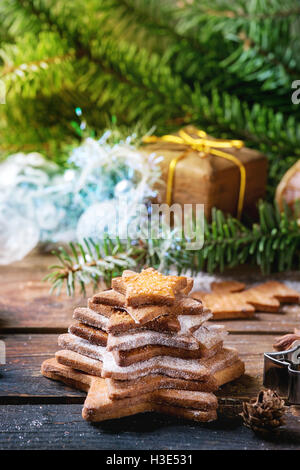 Pile de Noël fait maison shortbread cookies sucre étoile taille différente avec du sucre en poudre sur la surface en bois ancien avec Chri Banque D'Images