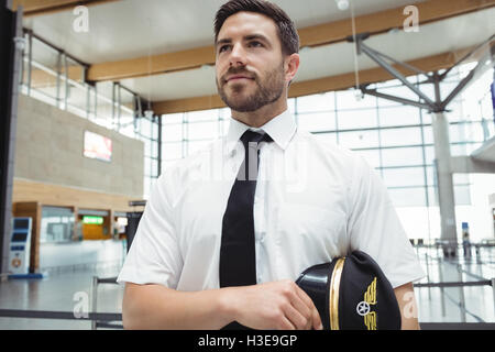 Pilot standing in airport terminal Banque D'Images