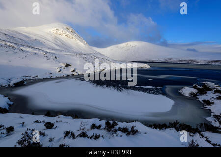 Lock Skeen partiellement congelée et les collines environnantes de la mi Craig (à gauche) et Lochcraig (derrière la tête) couverts dans la neige profonde Banque D'Images