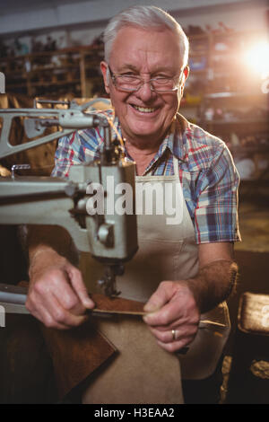 Portrait de shoemaker à l'aide de la machine à coudre Banque D'Images