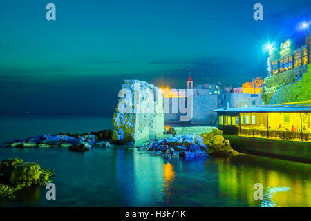 ACRE, ISRAËL - 18 octobre 2015 : le mur de la mer et saint Jean le Baptiste église franciscaine de nuit, avec des diners, dans l'ancien Banque D'Images