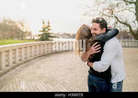 Young happy couple hugging in Battersea Park, London, UK Banque D'Images