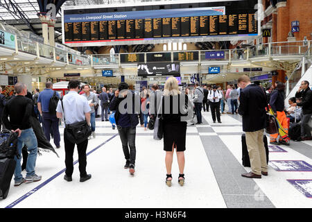 Les gens debout sur les navetteurs à l'intérieur du hall de la gare de Liverpool Street à la carte au départ pour les trains à Londres UK KATHY DEWITT Banque D'Images