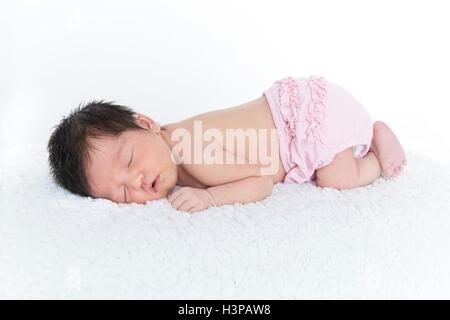 Parution du modèle. Naissance bebe Fille en rose nappy, endormi. Banque D'Images