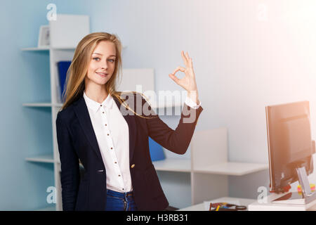 Femme fait signe OK en bleu office Banque D'Images